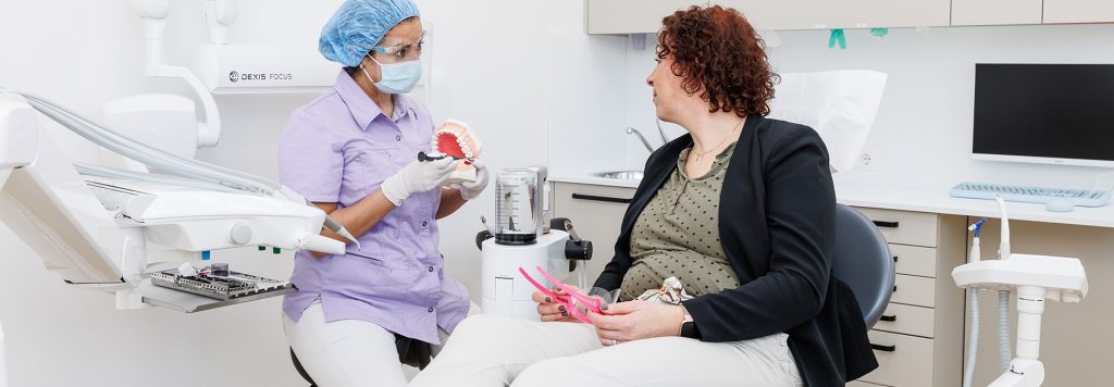 Mondhygienist geeft patiënt uitleg over tanden poetsen